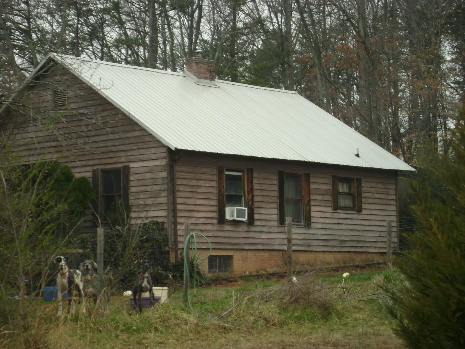 White metal roof on an old wood sided farmhouse, from a Metal Roof Installation job in Bellville